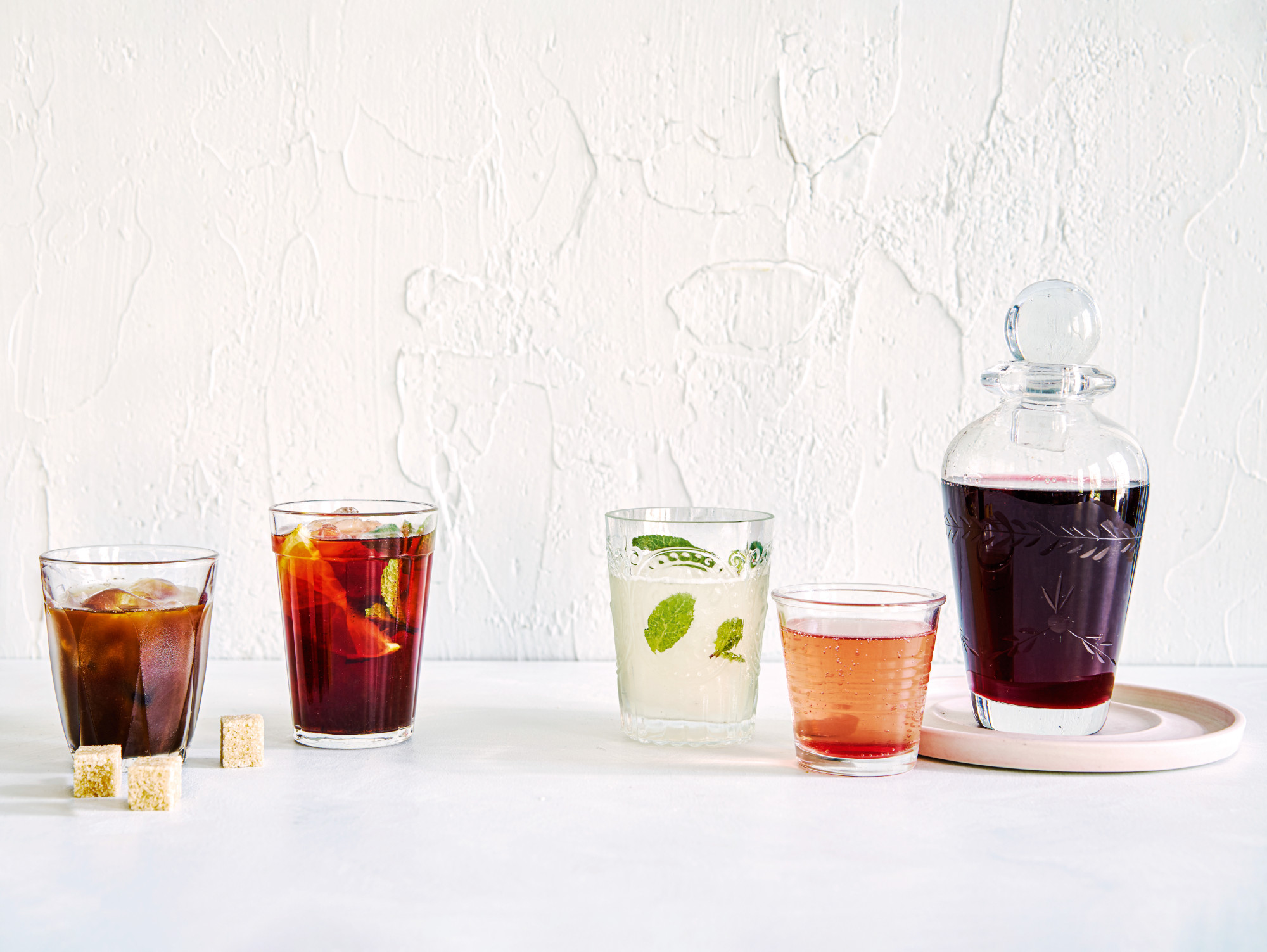 From left: Arabic iced coffee; hibiscus and orange iced tea; limonada; pomegranate and rose cordial