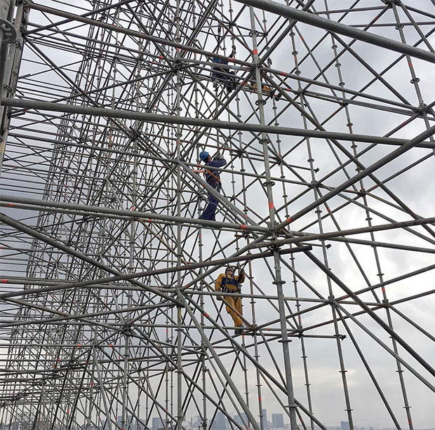 JR and his team install a new piece in Rio. Image courtesy of the artist's Instagram